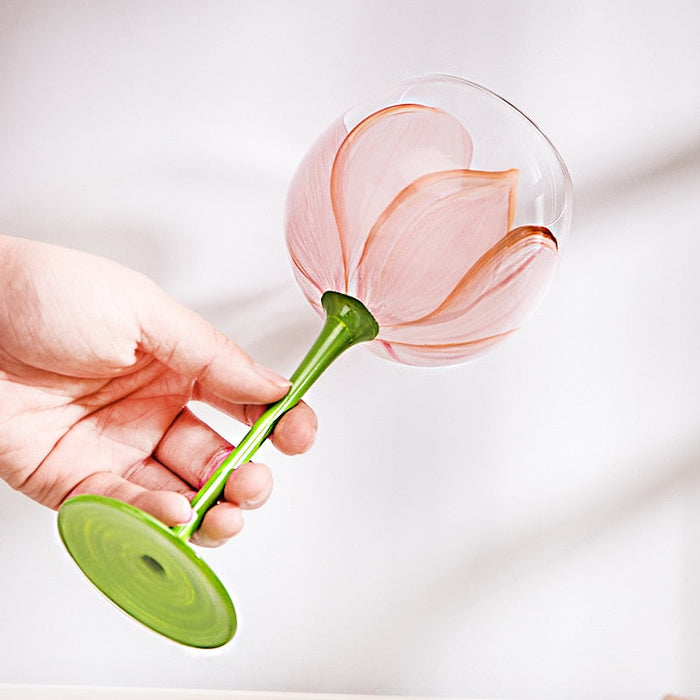 Flower-pattern stemmed glass, green stem, pink and orange petals on clear bowl