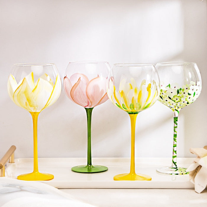 Set of four flower-pattern stemmed glasses with painted petals and green stems