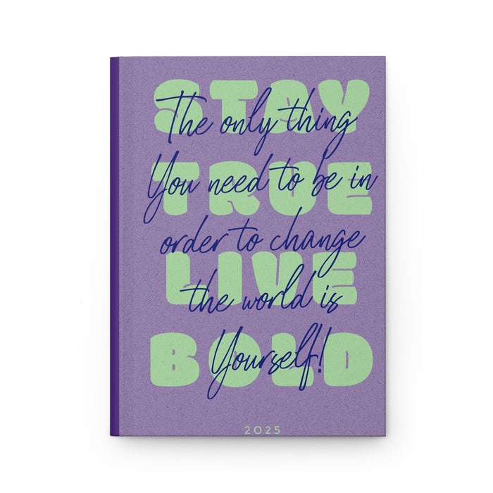 Hardcover journal with purple front cover and green slogan text; year 2025 at bottom.