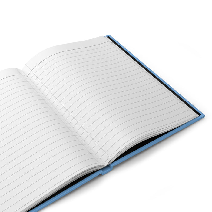 Open matte hardcover journal showing lined pages with blue edge binding