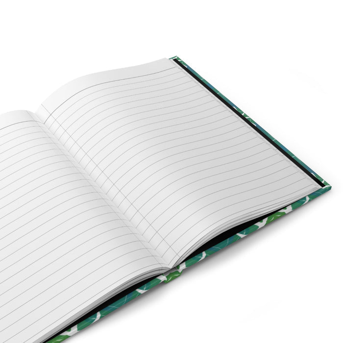 Hardcover journal open to ruled pages with teal-green patterned cover edge