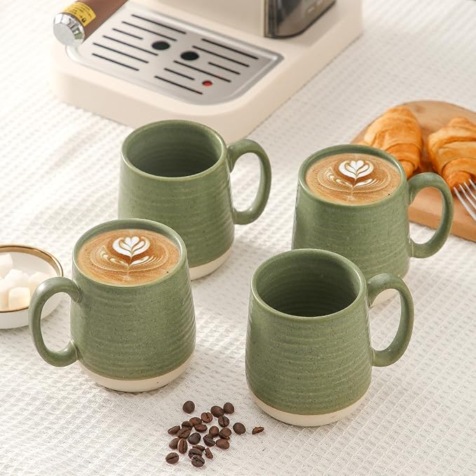 Green ceramic mugs set of 4 with handles, speckled glaze, filled with latte art