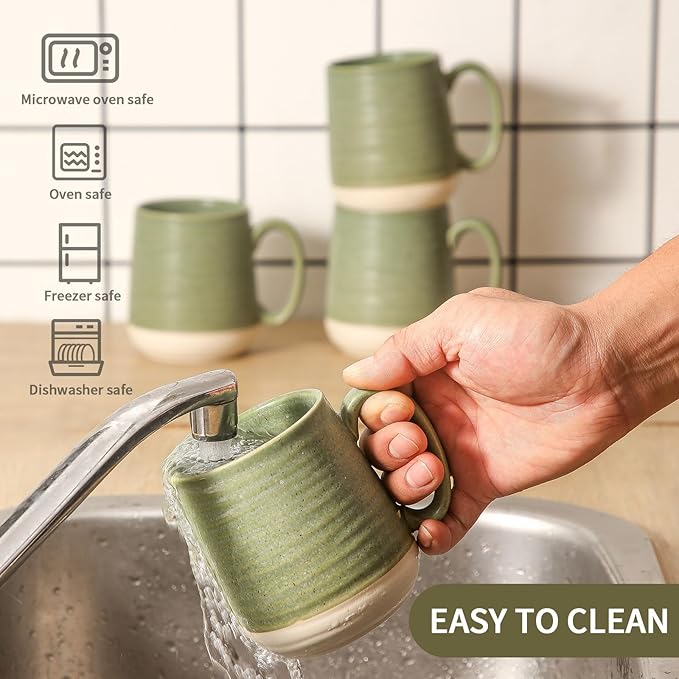 Green ceramic coffee mugs set of 4 with curved handles, being rinsed at sink