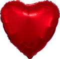 Red heart balloon close-up, shiny metallic surface and crimped seams