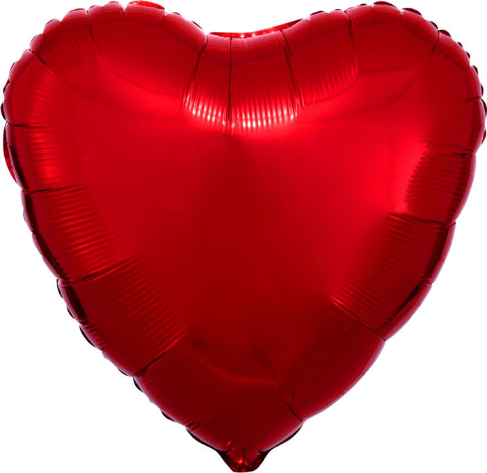 Red heart balloon close-up, shiny metallic surface and crimped seams