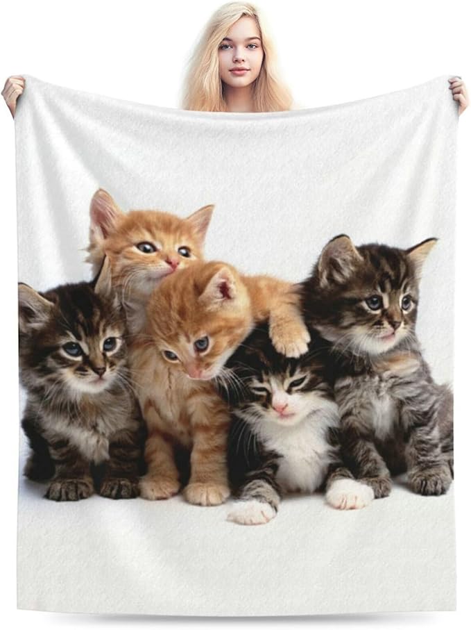 Cats throw blanket held up, white fleece with a group of kittens print