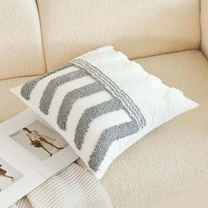 White pillow cover with thick gray arched lines on textured tufted front