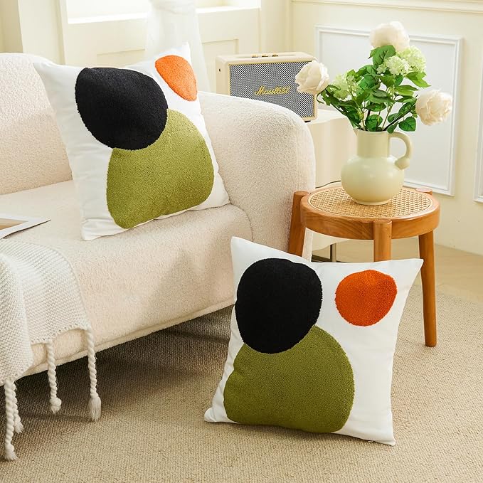 Tufted boho pillow cover with white background and black, olive-green, and orange circle design
