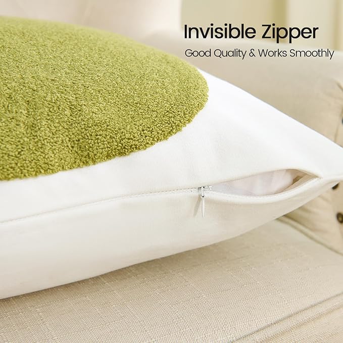 White pillow cover with zipper opening along side; olive-green tufted circle detail