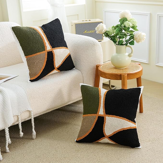 Pair of square tufted pillow covers with green, black, tan grid cross and orange border