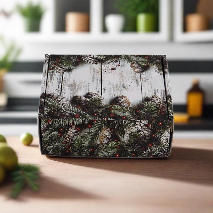 Decorative holiday gift box with evergreen wreath pattern, closed