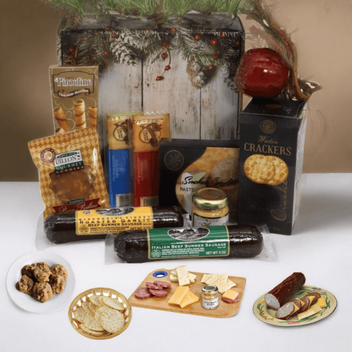 Holiday gift box with assorted snacks, crackers, and sausage arranged on a tray