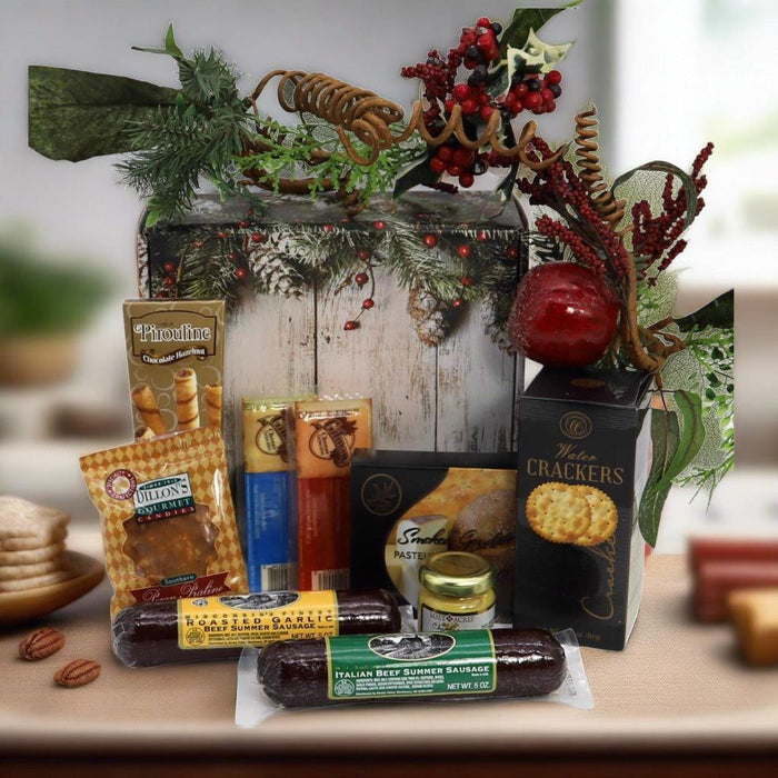 Holiday gift box with packaged treats and crackers, surrounded by seasonal greenery