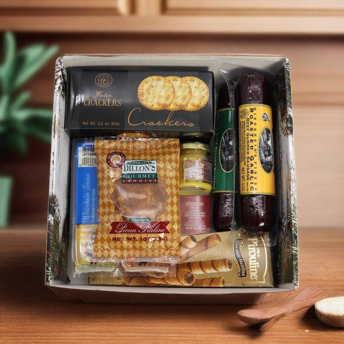 Holiday gift box open with crackers, sausages, and jars neatly arranged