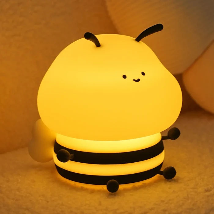Honey bee night light with warm yellow glow, smiling face, and three black band accents
