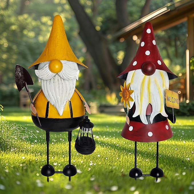 Metal gnome yard statues on grass: yellow-hat and red-hat with lantern and welcome tag