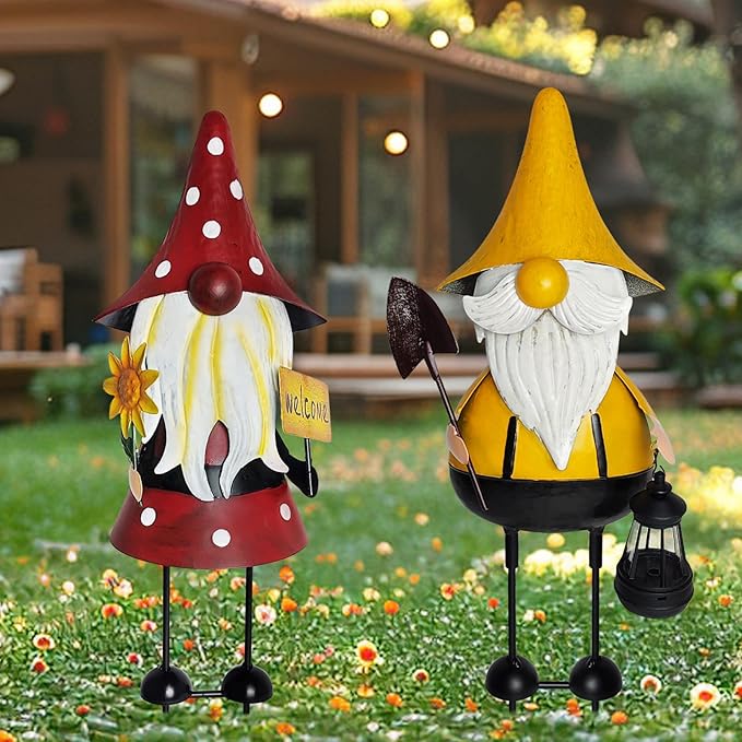 Pair of 3D metal gnome statues: red-hat and yellow-hat with white beards and signs