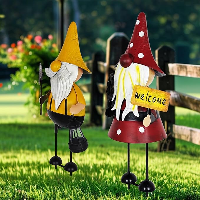 Two metal gnome yard statues with black bases: yellow-hat and red-hat on lawn