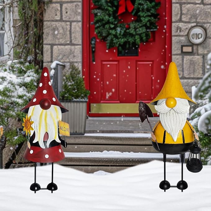 Snowy yard metal gnome pair: red-hat and yellow-hat statues with white beards