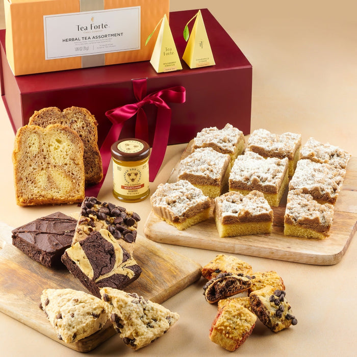 Assorted pastries and tea starter in a gift box with a red ribbon