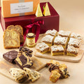 Assorted pastries and tea starter in a gift box with a red ribbon