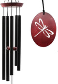 Outdoor wind chime with five black tubes and red dragonfly disc, hanging on hook.