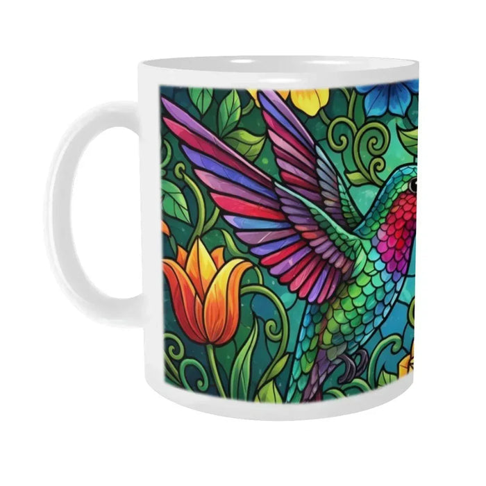Close-up of ceramic mug with hummingbird stained-glass artwork and white handle