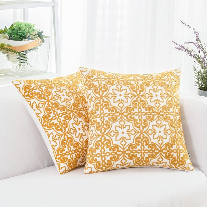 Mustard yellow and white embroidered throw pillow covers with ornate damask pattern
