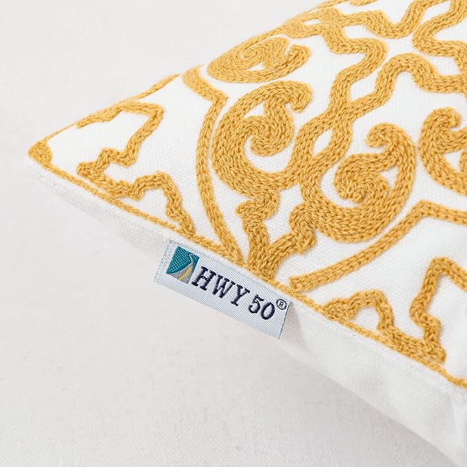 Mustard yellow and white embroidered throw pillow cover with HWY 50 label