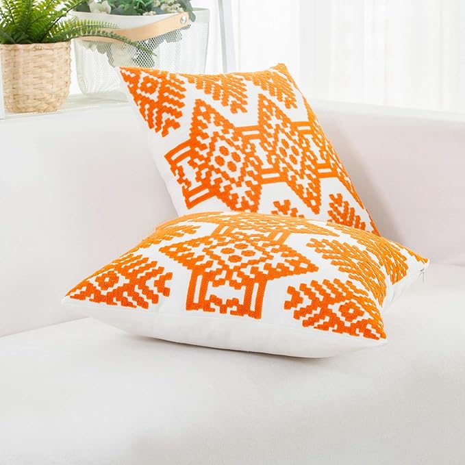 Orange embroidered throw pillow cover with white diamond and stripe pattern
