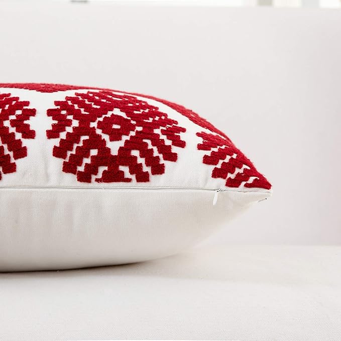 Red embroidered pillow cover edge with stitched border on white fabric