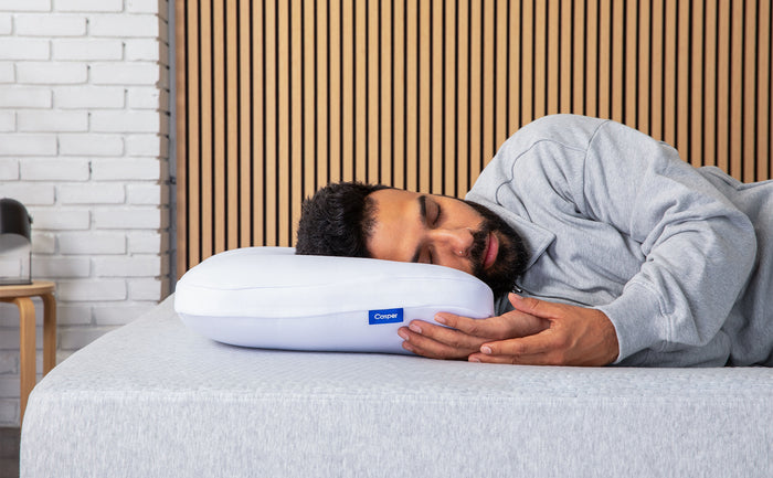 A person sleeping on his side on Casper's Hybrid Pillow.