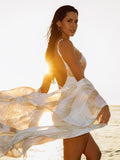 Model wearing the Ibiza Snake swimsuit and kaftan by NAIA Beach at sunset