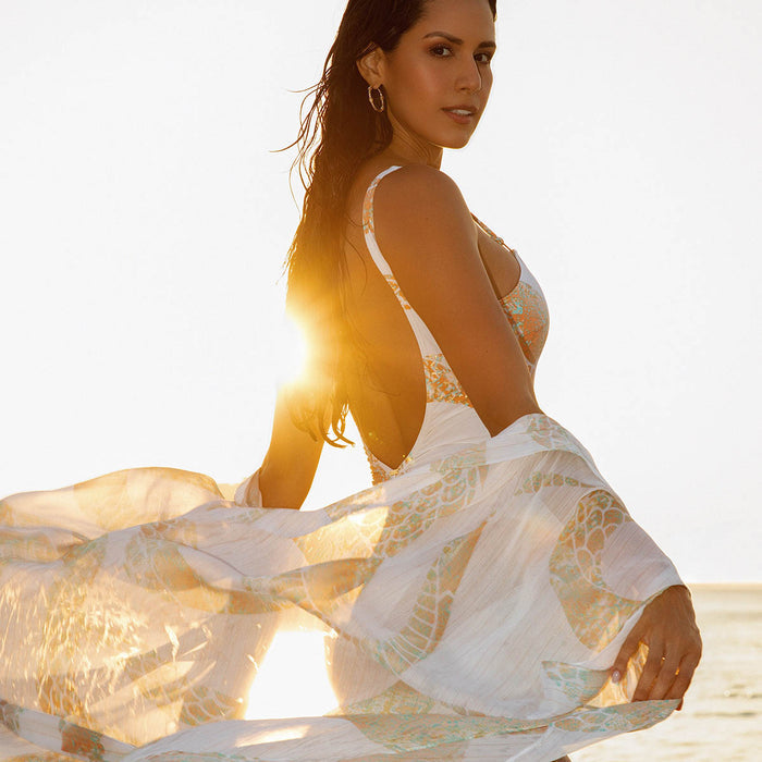 Model wearing the Ibiza Snake swimsuit and kaftan by NAIA Beach