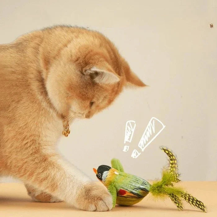 Orange cat batting a green plush bird teaser toy with feather tail and spring string