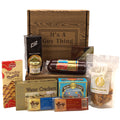Wooden gift box with Guy Thing label and assorted snack items inside