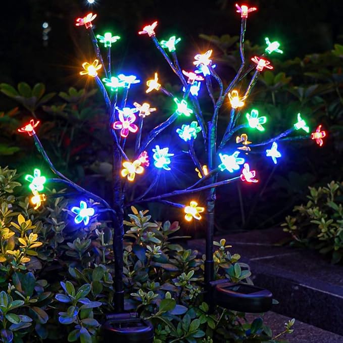 Solar butterfly flower garden lights with multicolor glowing petals on dark branches