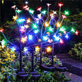 Solar flower string lights with multicolor LED butterflies on black branching stakes