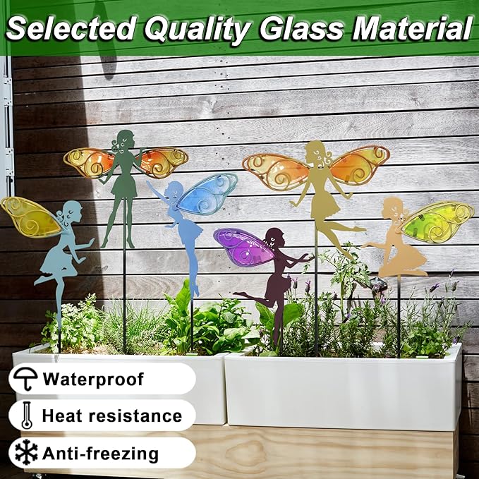 Multicolor fairy glass-wing metal garden stakes arranged in planter bed