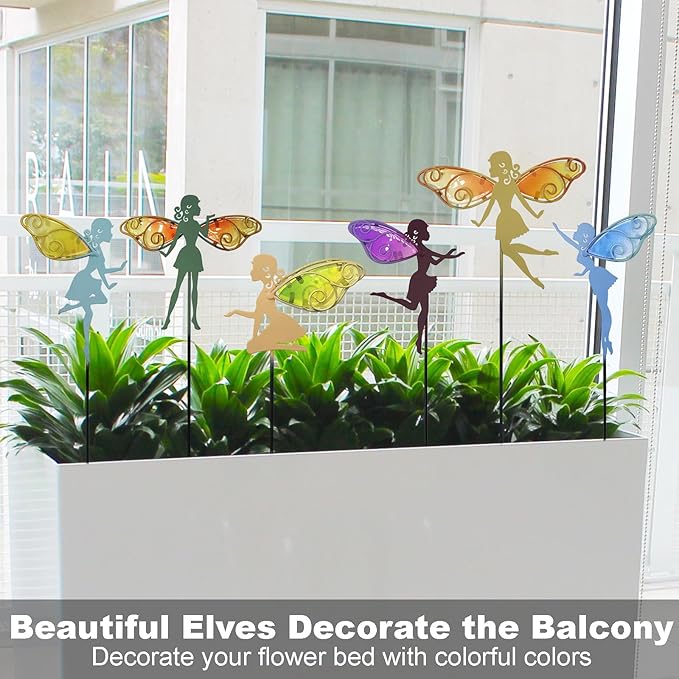 Colorful fairy garden stakes with glass wings in front of window greenery