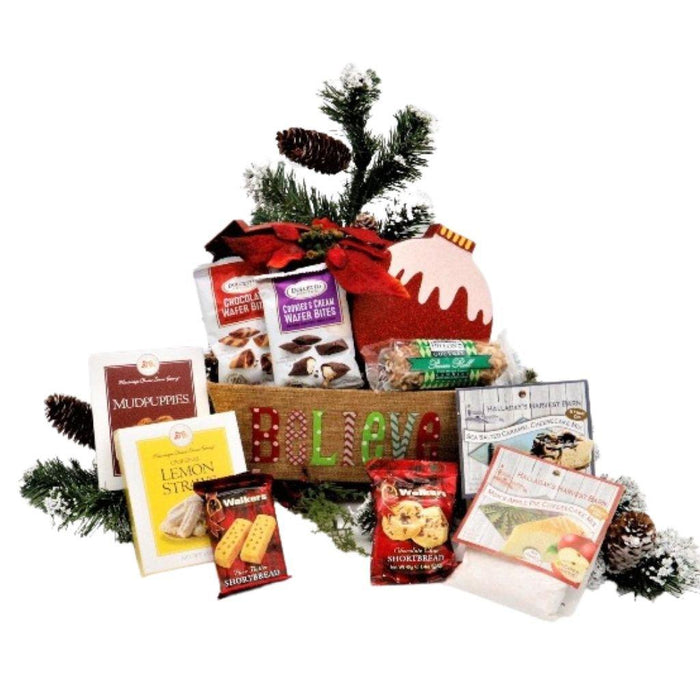 Holiday gift basket with assorted sweets, pine sprigs, and faux “Believe” sign