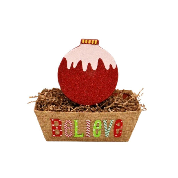 Burlap gift basket with red bauble topper and colorful “Believe” lettering