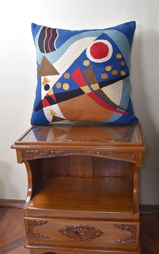 Blue abstract geometric pillow cover with red ring, cream shapes, and yellow dots