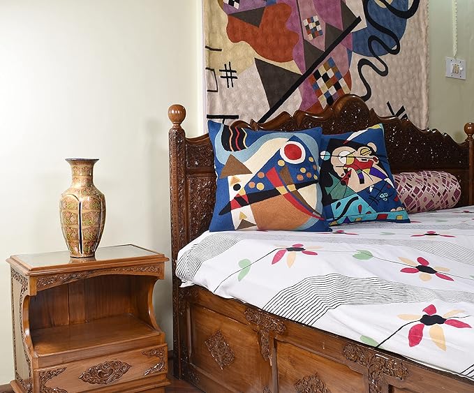 Blue abstract geometric pillow cover with colorful lines, triangles, and red circle