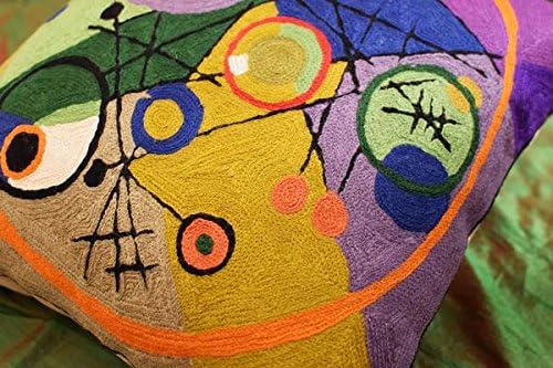 Close-up detail of multicolor abstract circle embroidery on a purple-edged pillow cover