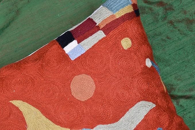 Orange abstract pillow cover close-up with striped block motif in blue and beige
