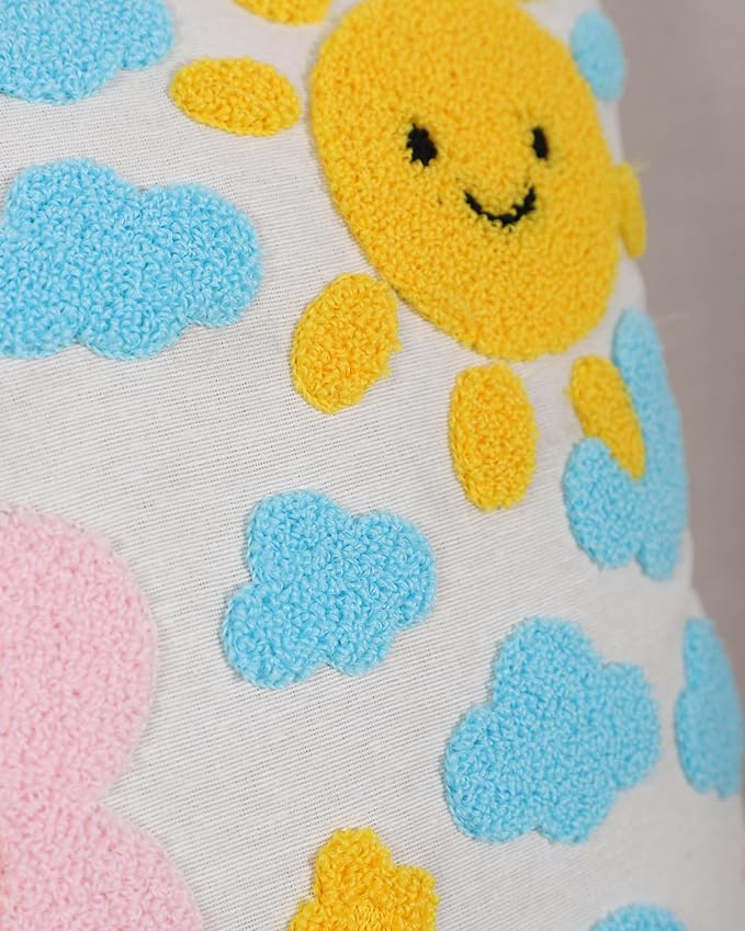 Handmade cotton throw pillow cover close-up with yellow smiling sun and blue cloud shapes