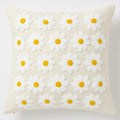 Natural cotton daisy throw pillow cover with white petals and yellow centers, textured stitch