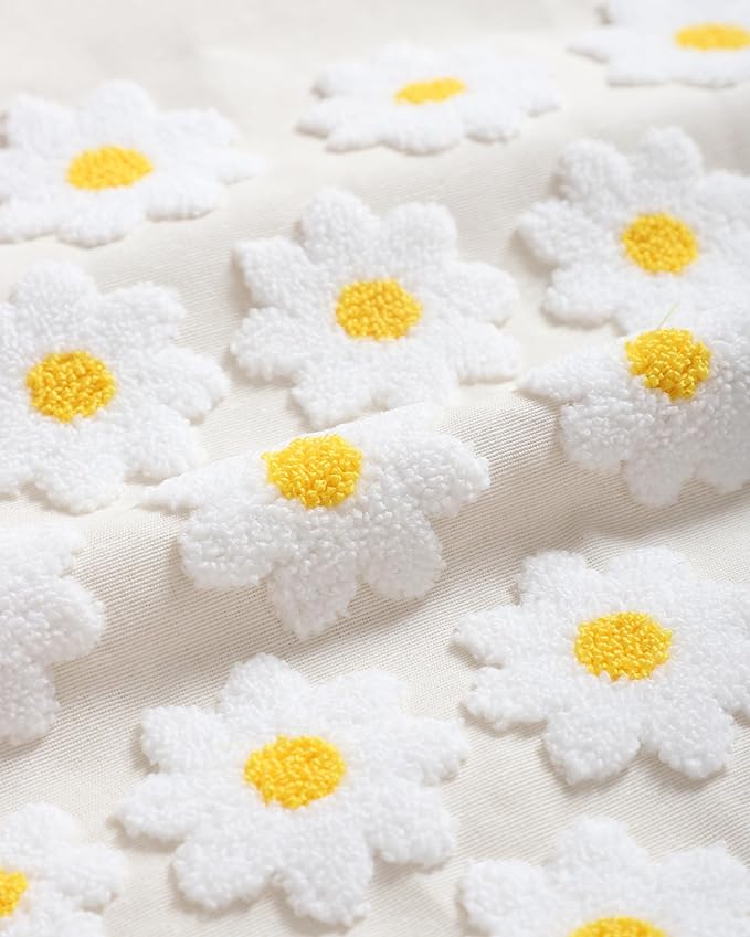Textured daisy pattern on cream pillow cover: white blooms with yellow centers