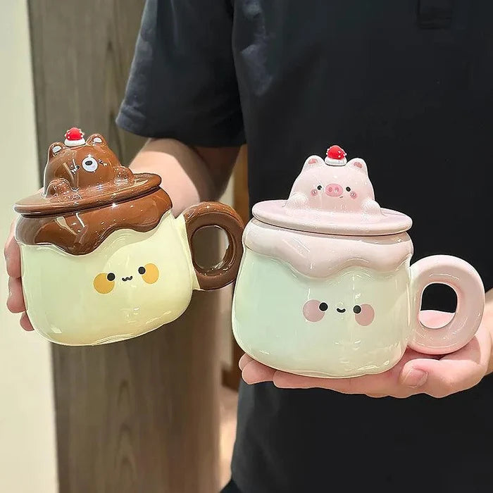 Two ceramic animal pudding mugs: brown bear with swirl lid, pink pig with strawberry lid